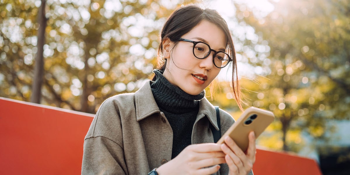 woman looking at mobile phone