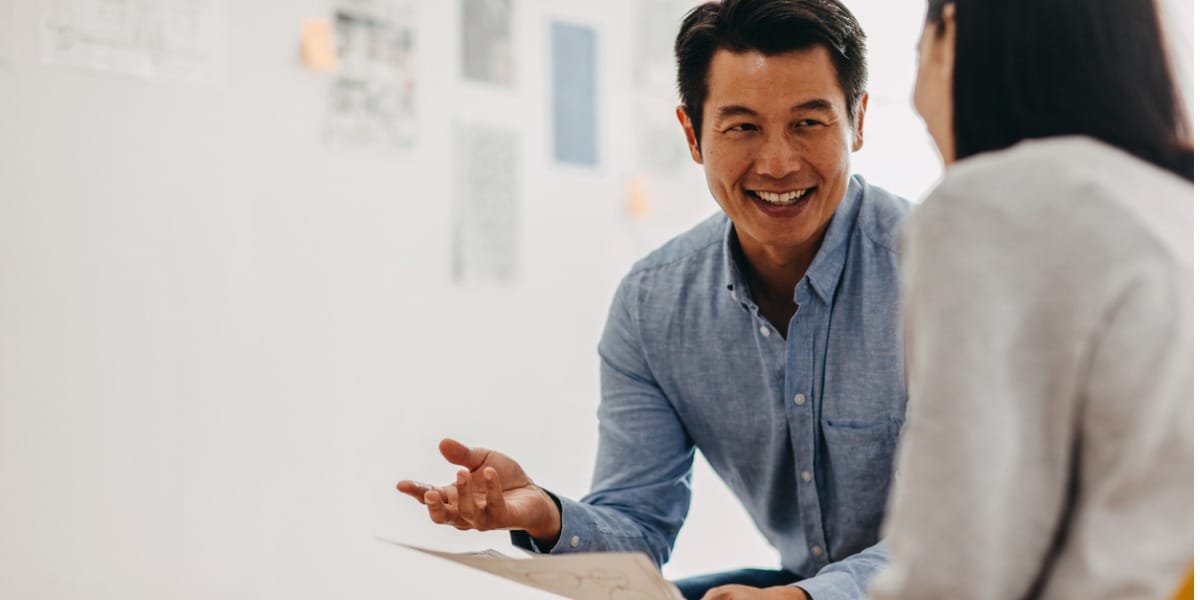 man talking and laughing with colleague 